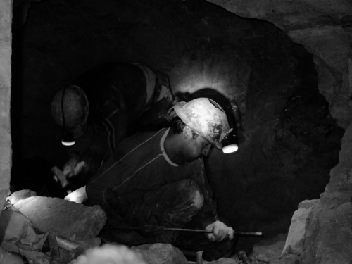 Miners hard at work hand-drilling holes for dynamite
